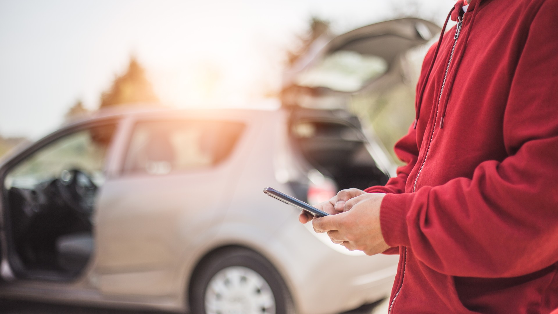 handsome young Hispanic crashed with his car using his cell phone. road safety concept